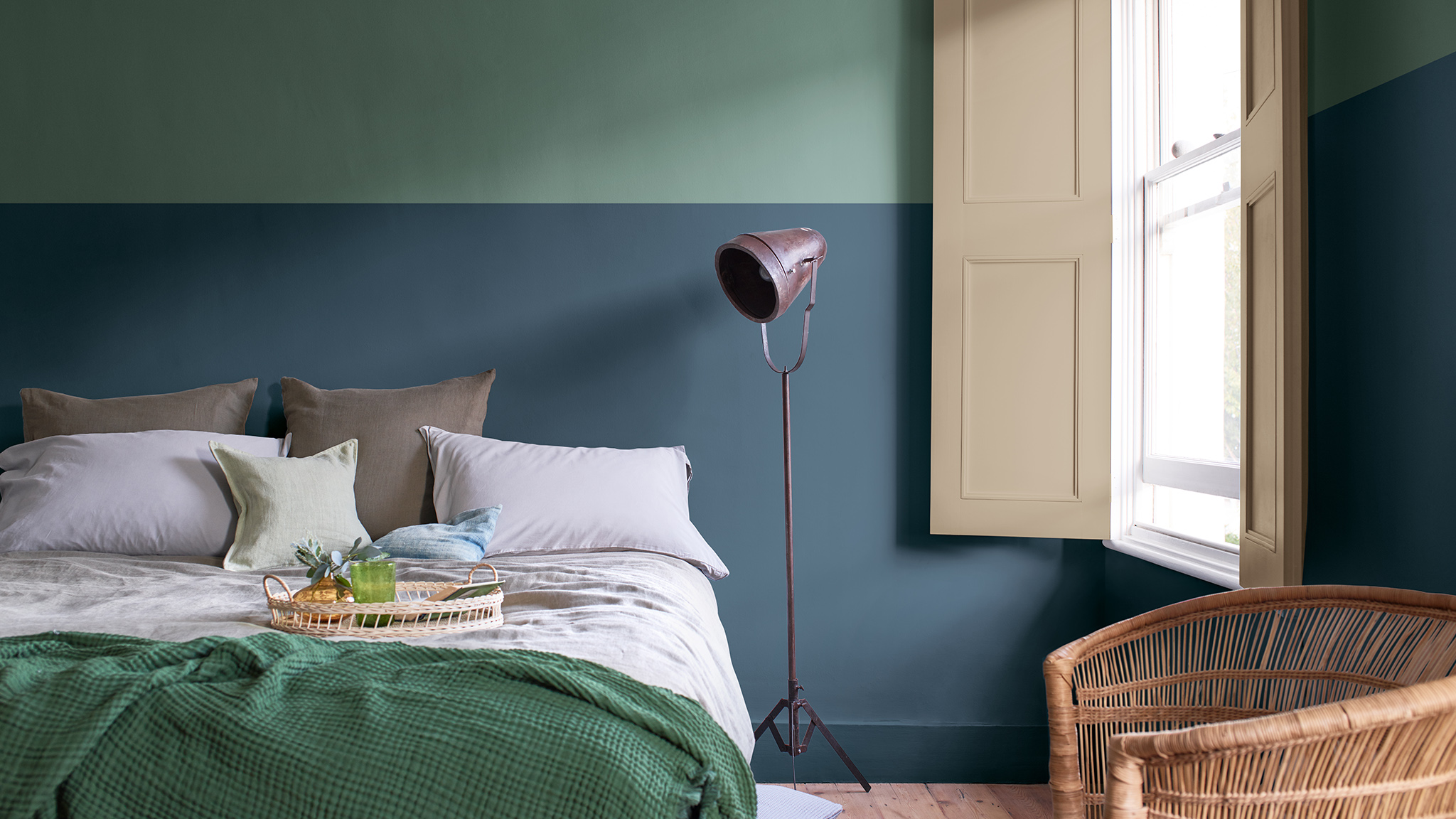 Bedroom painted with a two tone split wall in deep blue and sage green Dulux_CF21_Colour_of_the_year_Earth_colors_global_1