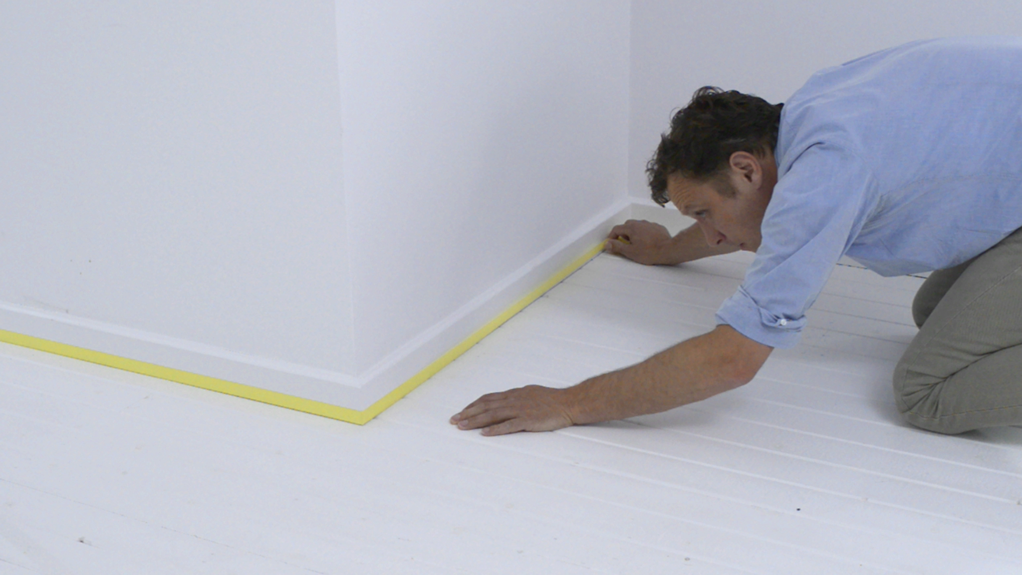 Masking the edge of the skirting board Dulux_painting_wooden_flooring_UK_5